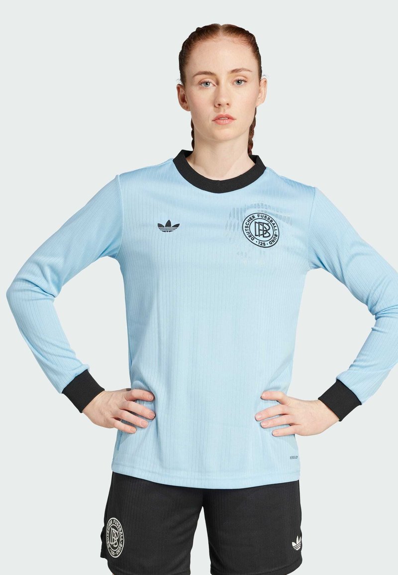 Light blue long-sleeve soccer jersey with black accents. Features ribbed texture and embroidered logo on the chest, paired with black shorts.