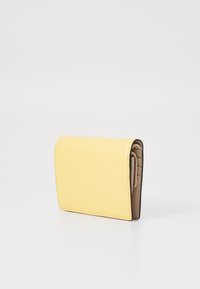Yellow leather wallet with a textured finish, folded design, and contrasting interior color. Compact shape with visible stitching details.