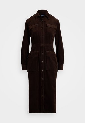 Brown corduroy shirt dress featuring a button front, two chest pockets, and two side pockets. Long sleeves with buttoned cuffs.
