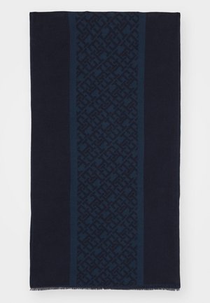 Écharpe bleu marine foncé avec une bande centrale verticale présentant un motif géométrique ton sur ton et des bords frangés.