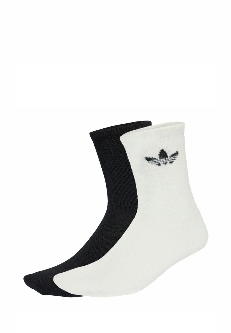 Black and white ankle socks with ribbed texture; features a logo on the white side. The black sock has a smooth finish.