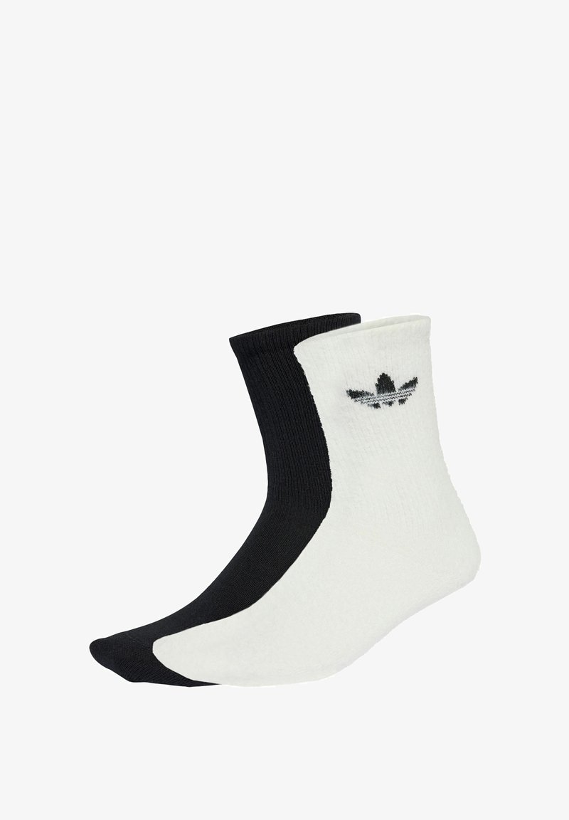 Black and white ankle socks with ribbed texture; features a logo on the white side. The black sock has a smooth finish.