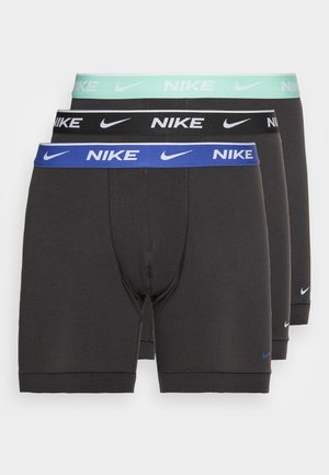 Pack of three black Nike boxer briefs, featuring contrasting elastic waistbands in mint green, black, and blue with white logo accents.