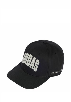 Black cap made of fabric with a curved brim. Features large white "ADIDAS" text on the front and "SPORTSWEAR" text on the side.