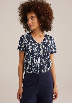 Navy V-neck t-shirt featuring a white and teal abstract pattern. Short sleeves and a relaxed fit. Smooth, soft fabric texture.
