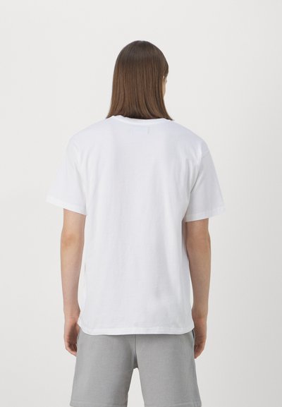 White cotton t-shirt with short sleeves and a straight cut. Features a simple design and soft texture. No visible graphics or patterns.