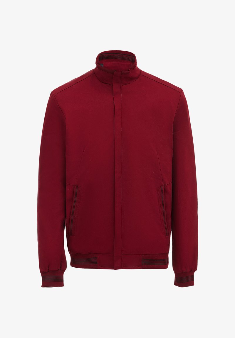 Red jacket with a high collar, two side pockets, ribbed cuffs, and a smooth texture. Features minimalistic design and no visible fasteners.