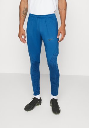 Blauwe sportbroek met een getailleerde pasvorm, voorzien van textuurpanelen en een zwart Nike-logo. Gemaakt van lichtgewicht, ademend materiaal.