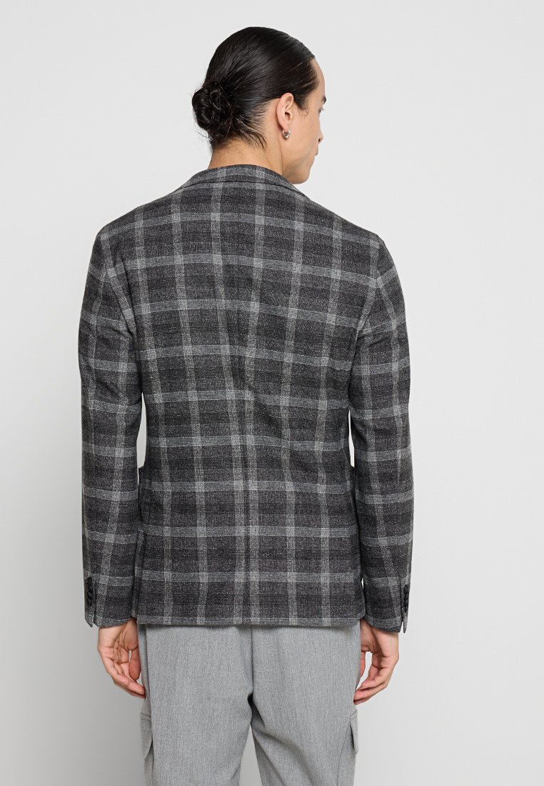 Grau kariertes Blazer mit einem strukturierten Stoff. Verfügt über einen Reverskragen, einen einzelnen Rückenschlitz und zwei seitliche Taschen, die eine taillierte Passform bieten.