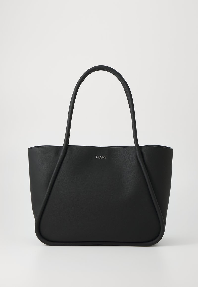 Sac fourre-tout noir en matériau synthétique texturé avec des poignées allongées et un design minimaliste ; porte le logo "HUGO" à l'avant.