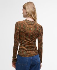 Chemise à manches longues, ajustée, de couleur vert foncé avec des motifs floraux orange. Présente une texture froncée à l'arrière et un col rond.