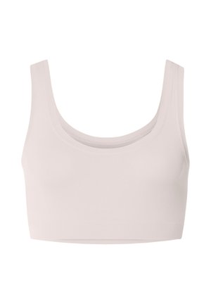 Světlé béžové sportovní podprsenka bez švů se širokými ramenními pásky a hlubokým výstřihem.