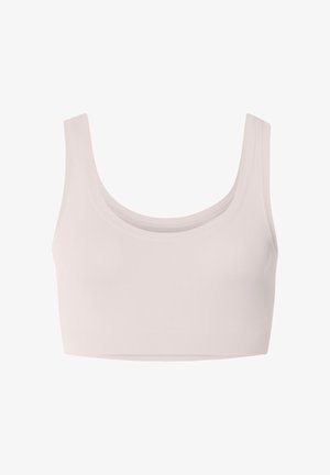 Světlé béžové sportovní podprsenka bez švů se širokými ramenními pásky a hlubokým výstřihem.