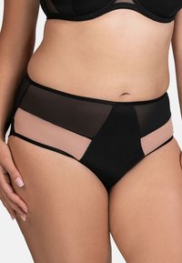 Hochgeschnittene Unterwäsche mit schwarzen und hautfarbenen Mesheinsätzen. Aus weichem Stoff gefertigt, mit glatter Textur und kontrastierenden Farben in einem geometrischen Design.