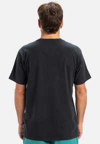 Black cotton t-shirt with a round neckline and short sleeves. The back features a plain design without logos or patterns.