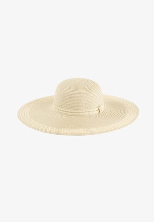 Szeroki kapelusz słomkowy w kolorze kremowym, z wyraźnym, teksturowanym wzorem i delikatnym paskiem akcentującym u podstawy korony.