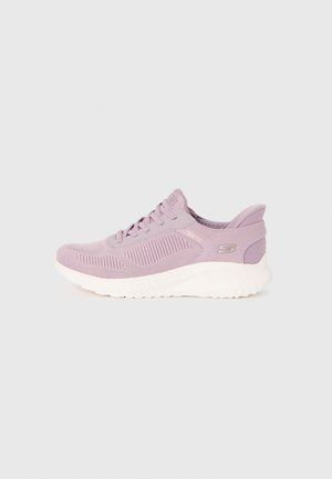 Light purple athletic shoe with a textured mesh upper, white rubber sole, and decorative accents. Features laces and a cushioned heel.