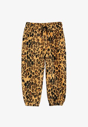 Tepláky s leopardím vzorem v béžové a černé barvě, vyrobené z měkké tkaniny, s elastickým pasem na šňůrku a manžetami.