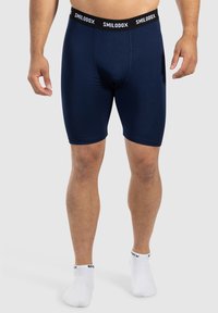 Shorts aderenti blu navy realizzati in tessuto morbido, con una vita elastica nera che presenta il marchio "SMILODOX" in bianco e una tasca frontale di supporto.