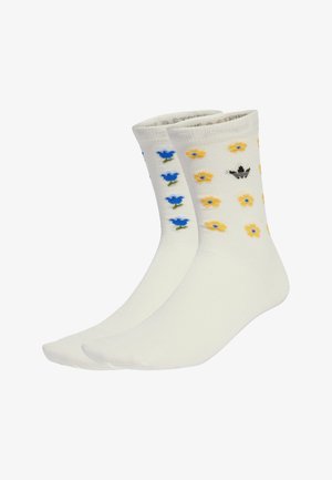 White cotton crew socks featuring blue and yellow floral patterns and a small black logo. Soft texture, standard height, and fitted design.