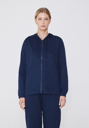 Veste à zip bleu marine en tissu doux, dotée d'une capuche, de poches avant et de poignets côtelés pour un ajustement décontracté.