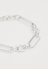 Silver chain bracelet featuring a mix of round and rectangular links, polished finish, and smooth texture. Suitable for casual or formal wear.