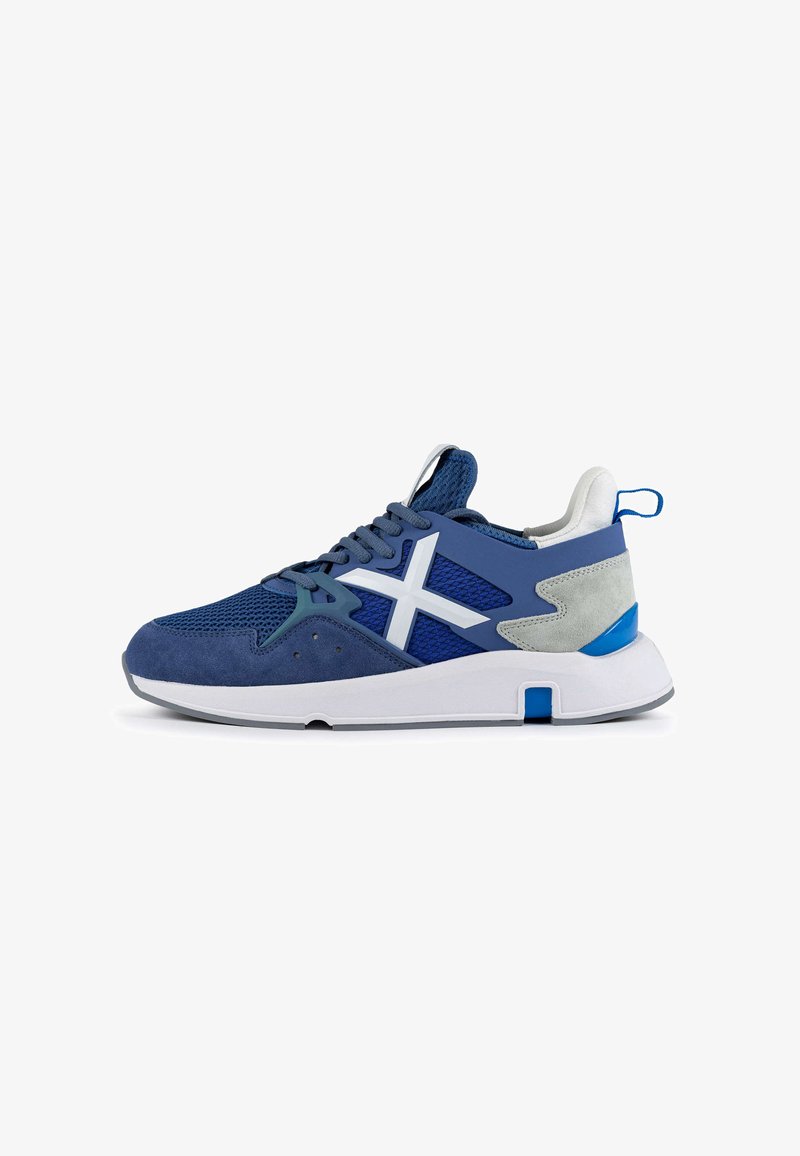 Blue athletic shoe featuring a mesh and suede upper, textured accents, white logo, and a cushioned sole with a blue heel accent.