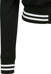 Black sweatshirt cuff featuring a ribbed texture with two white stripes running horizontally. The fabric appears soft and slightly stretchy.