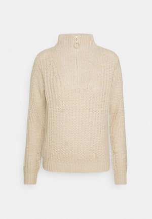 Beige gebreide trui met lange mouwen, hoge kraag en een rits aan de achterkant. Texture stof met geribbelde manchetten en zoom.