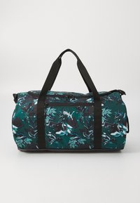 Duurzame tas met een teal abstract bloemmotief, zwarte accenten, stevige zwarte handvatten en een ritsvak aan de voorkant. Gestructureerde stof.