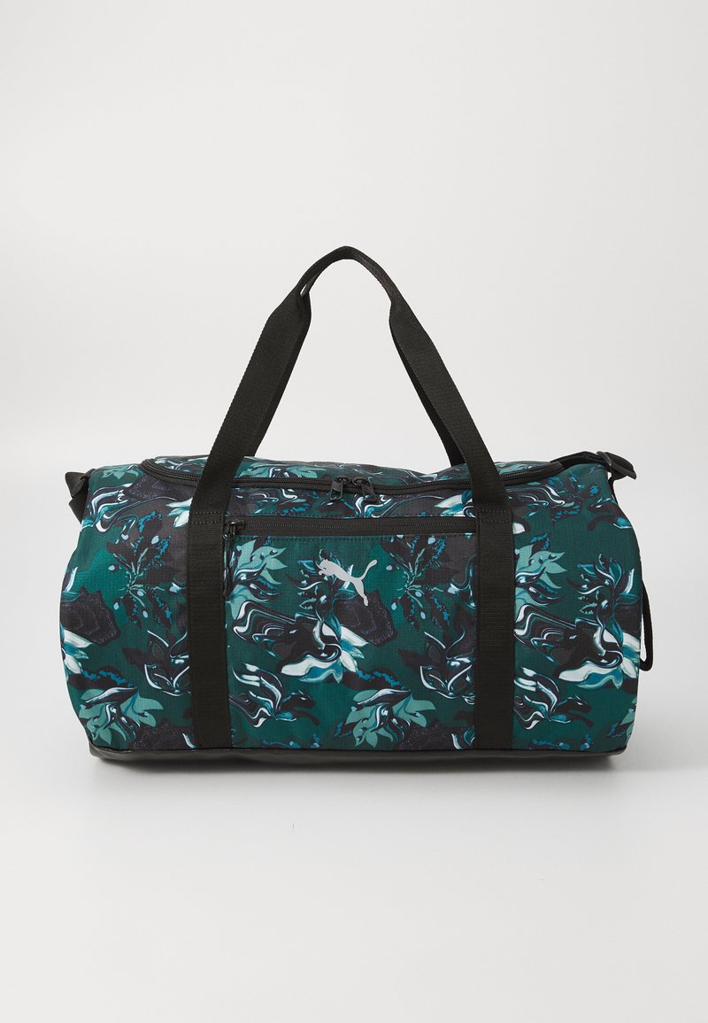 Duurzame tas met een teal abstract bloemmotief, zwarte accenten, stevige zwarte handvatten en een ritsvak aan de voorkant. Gestructureerde stof.