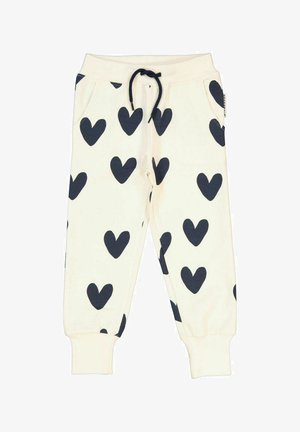 Hvide sweatpants med store marineblå hjerte-mønstre, elastisk talje med snoretræk, stiklommer og tætsiddende manchetter ved anklerne.