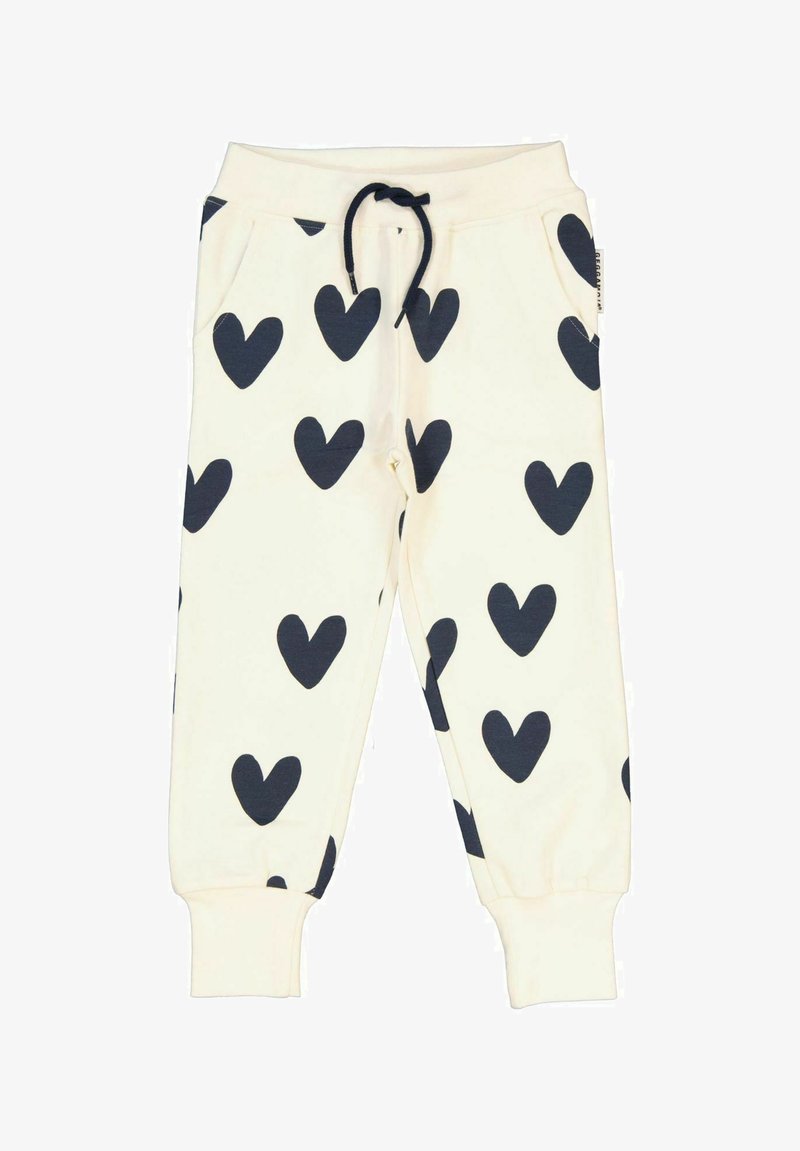 Hvide sweatpants med store marineblå hjerte-mønstre, elastisk talje med snoretræk, stiklommer og tætsiddende manchetter ved anklerne.