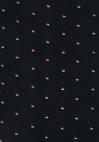 Ciemny materiał z wzorem składającym się z małych czerwonych i białych kropek na czarnym tle, o teksturowanej, tkanej powierzchni.