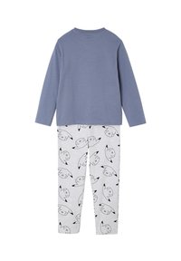 Long-sleeve plain blue top with light gray pants patterned with black-and-white cartoon faces on a white background.