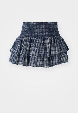 Jupe plissée à carreaux bleu marine avec une taille élastique smockée, présentant des couches de volants avec des motifs de grille blanche et une finition texturée.