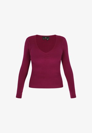 Slim Fit, langärmliger Pullover aus geripptem Stoff. Tiefer V-Ausschnitt in einem lebhaften Magentaton mit nahtlosem Design und ohne zusätzliche Verzierungen.
