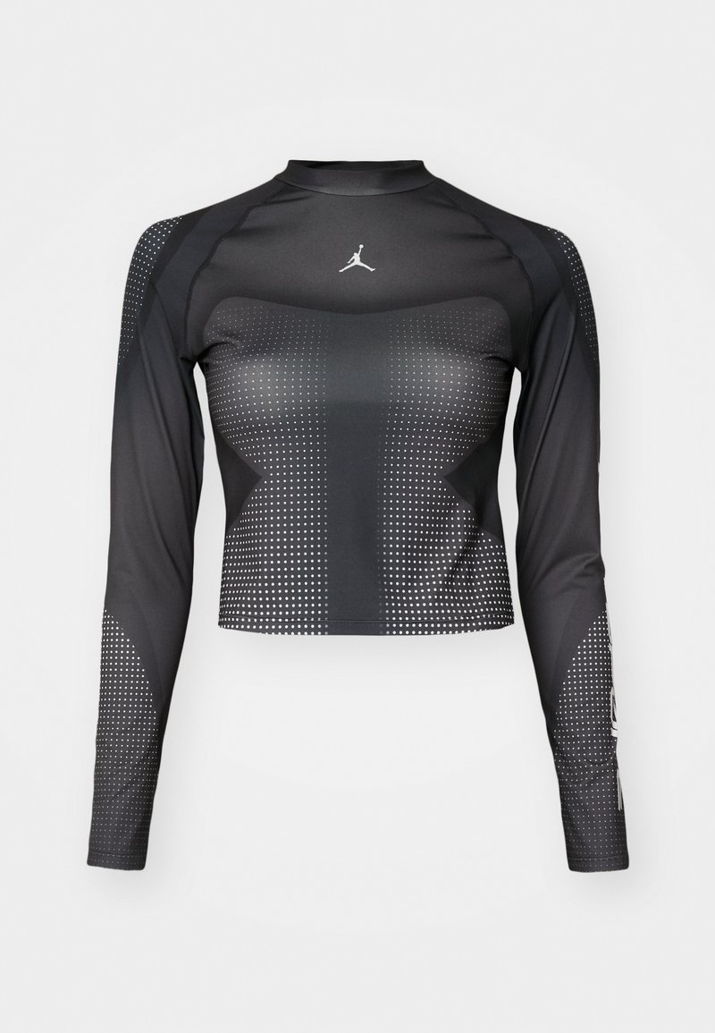 Maglietta sportiva nera a maniche lunghe con un design aderente, caratterizzata da motivi a pois e un piccolo logo sul petto. Realizzata in un tessuto liscio e elasticizzato.