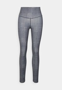 Legginsy z wysokim stanem w czarno-białym geometrycznym wzorze. Wykonane z elastycznego materiału, z dopasowanym krojem nogawki o gładkiej fakturze.