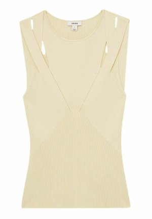 Úzký béžový top s V výstřihem, otevřenými ramenními výřezy a geometrickými švy. Vyrobeno z měkké elastické látky.