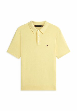 Gelbes Poloshirt mit kurzen Ärmeln, drei weißen Knöpfen und einem kleinen Tommy Hilfiger-Logo auf der linken Brust.