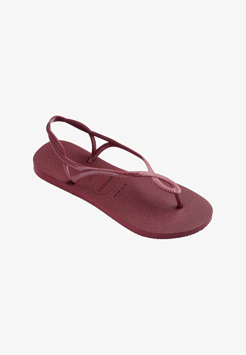 Infradito borgogna con suola in gomma testurizzata e cinturini intrecciati. Il design presenta uno stile a infradito con profilo piatto.