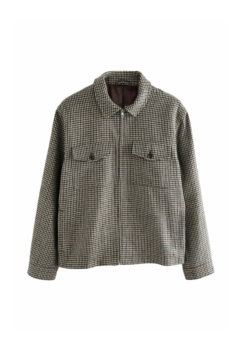 Fekete és krémszínű kockás dzseki, cipzárral, széles gallérral és két mellzsebbel. A texturált anyag otthoni mintázatú.