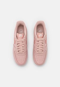 Nike Air Force 1-sneakers i ljusrosa läder med meshdetaljer, rund tå, perforerad ovandel och platta skosnören. Märkbar logotyp på tungan.