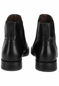 Black leather ankle boots with a smooth finish, featuring a flat sole, round toe, and subtle stitching details on the back.
