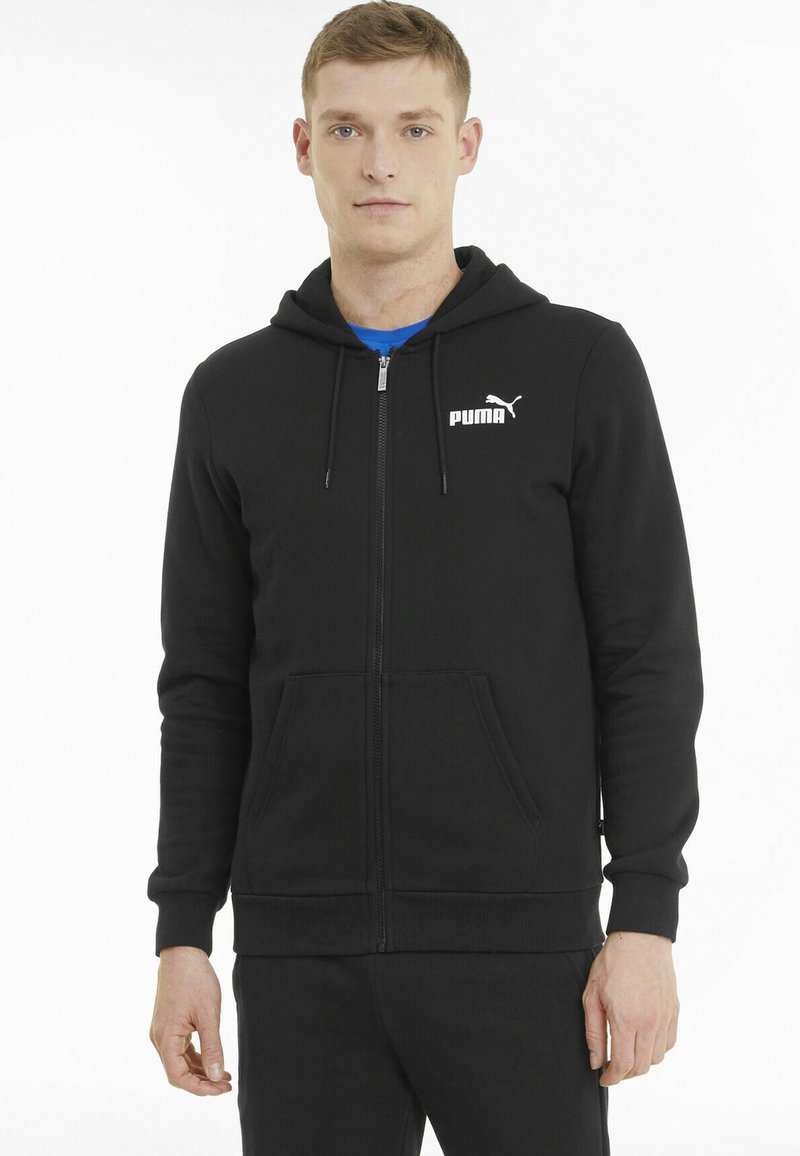 Felpa nera con zip realizzata in misto cotone. Presenta una tasca frontale, polsini a costina e un logo Puma bianco sul petto.