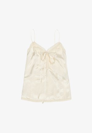 Zijde camisole in crème, met verstelbare bandjes, een kantafwerking langs de halslijn en een strikdetail in het midden. Gladde textuur met een subtiele glans.