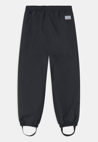 Svarta träningsbyxor med elastisk midja, justerbara muddorna och en rektangulär logotyp som har cirklar. Tillverkade av ett mjukt och lätt material.