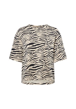 Chemise à manches courtes en crème avec des rayures noires de zèbre ; coupe décontractée, encolure ronde et ourlet légèrement courbé. Tissu doux et léger.