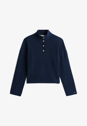 Maglione a coste blu navy con colletto alto, cinque bottoni in ottone al collo e maniche lunghe. Presenta un design cropped e un tessuto testurizzato.